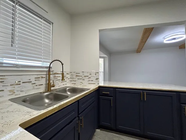 a kitchen with a sink and cabinets