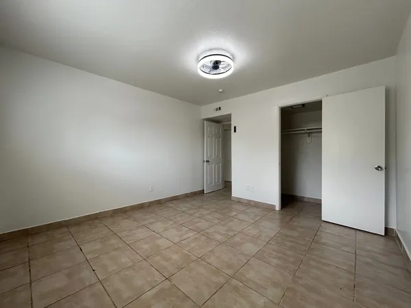 a bathroom with a granite countertop toilet sink and mirror