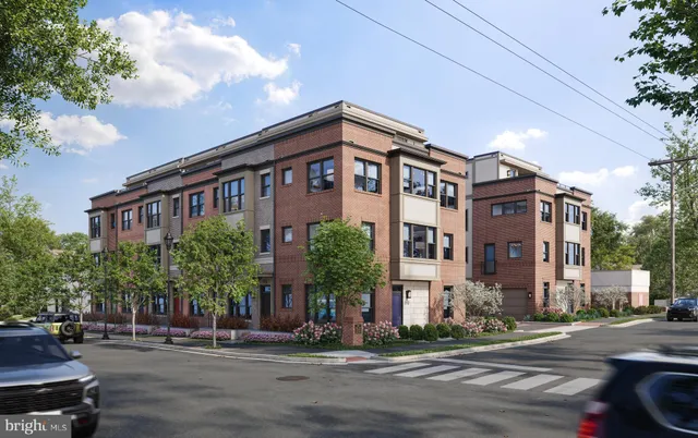 a front view of a building and car parked