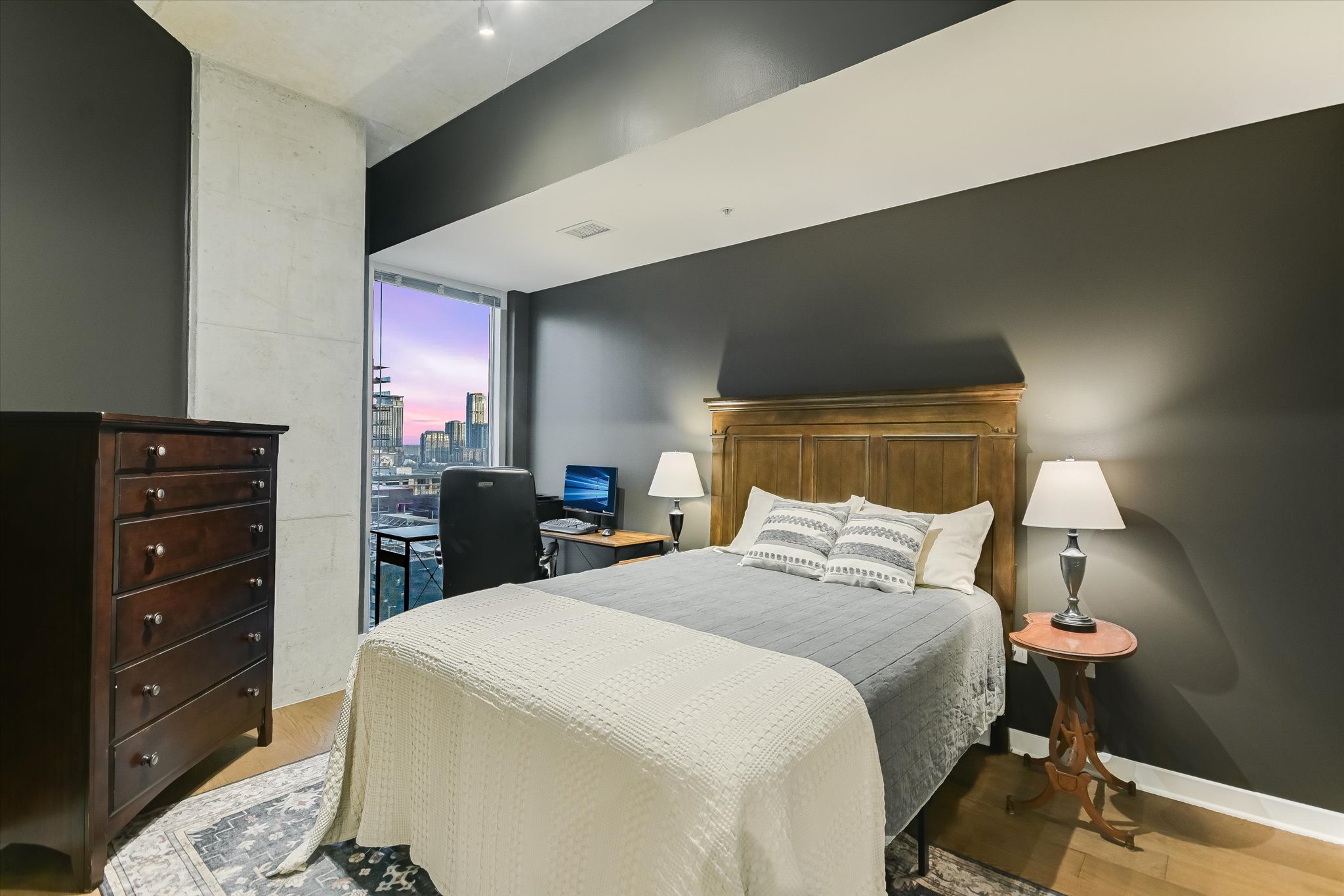 360 Nueces Street, Unit 1405 Austin, TX 78701 - Photo 21 of 40 a bedroom with a bed and a dresser