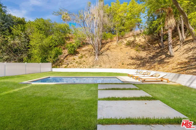 a view of a house with a yard and sitting area