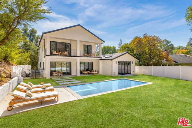 a view of house with outdoor space and swimming pool