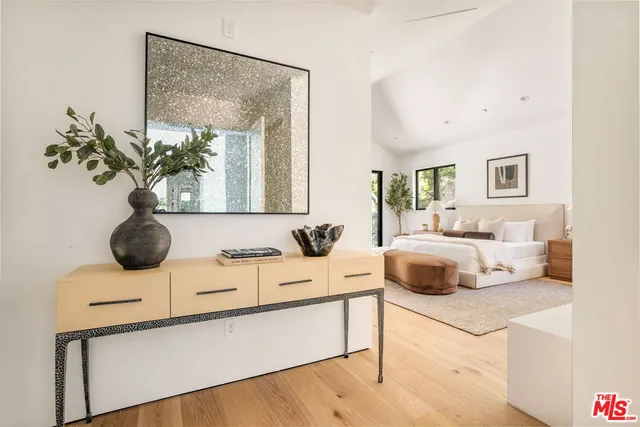 a spacious bedroom with a large bed and a large window