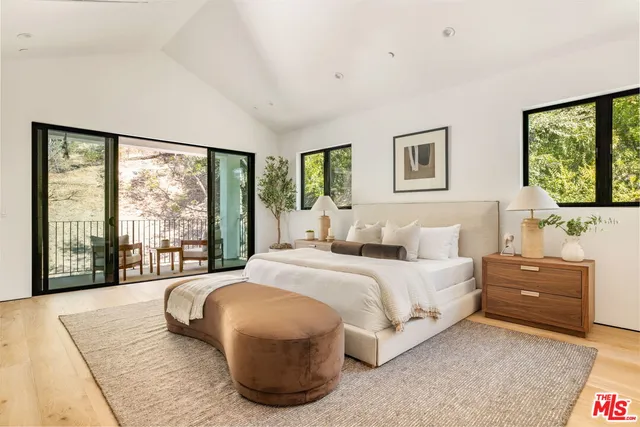 a spacious bedroom with a large bed and a fireplace