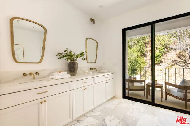 a spacious bedroom with a bed and a dresser