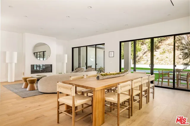 a large white kitchen with wooden floor