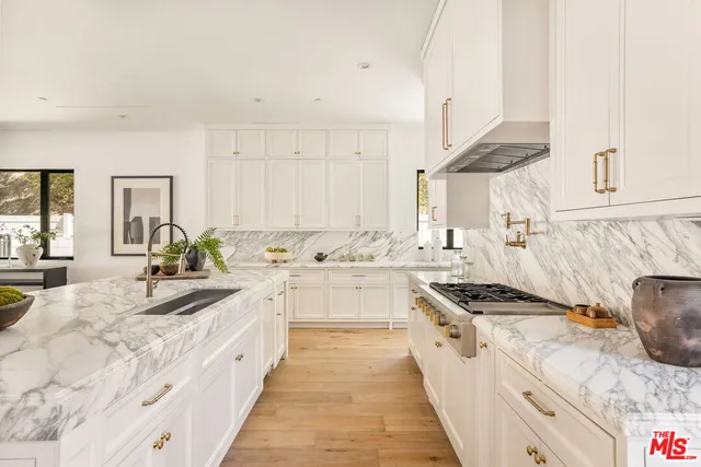 a bathroom with a granite countertop double vanity sink and bathtub