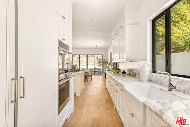 a view of a kitchen counter space and living room