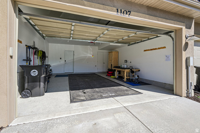 1107 West Wasatch Springs Road, Unit M3 Heber City, UT 84036 - Photo 24 of 34 Attached two-car garage with a light-toned overhead door and concrete flooring