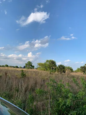 a view of a lake and green valley
