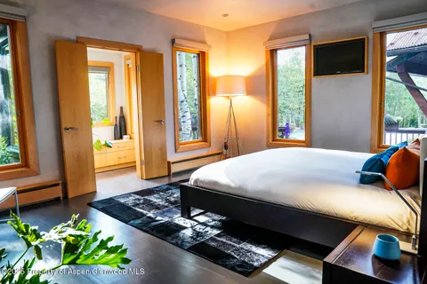 a bedroom with a bed and wooden floor