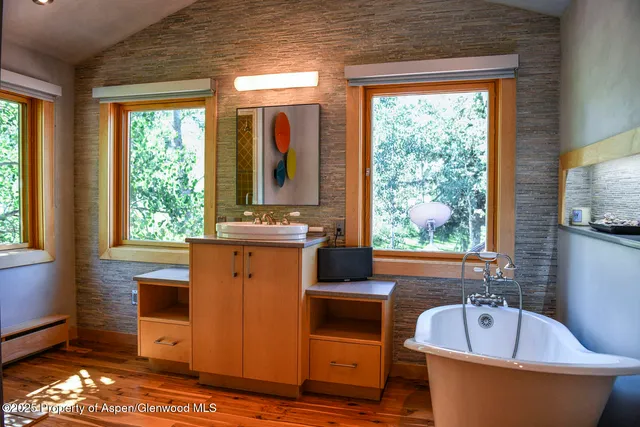 a bedroom with two beds and a large window