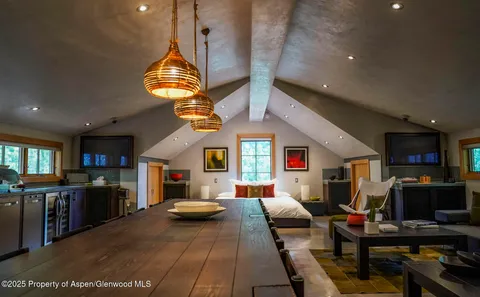 a large kitchen with a table and chairs