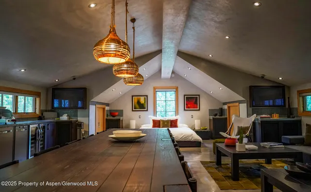 a large kitchen with a table and chairs