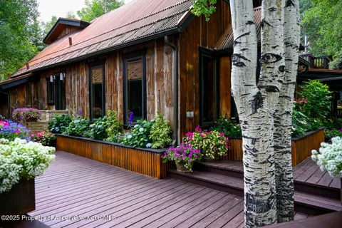 a view of a house with a flower garden