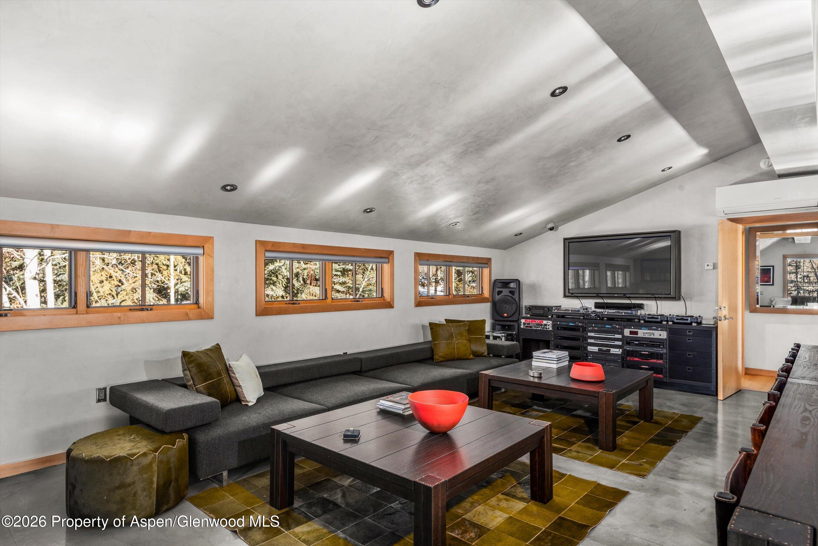 1038 Owl Creek Road Aspen, CO 81611 - Photo 34 of 44 a living room with furniture and a flat screen tv