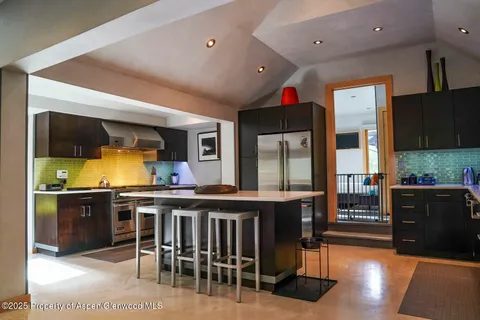a living room filled with furniture and a floor to ceiling window