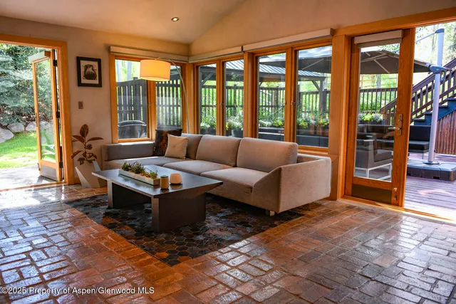 a living room with furniture and large windows