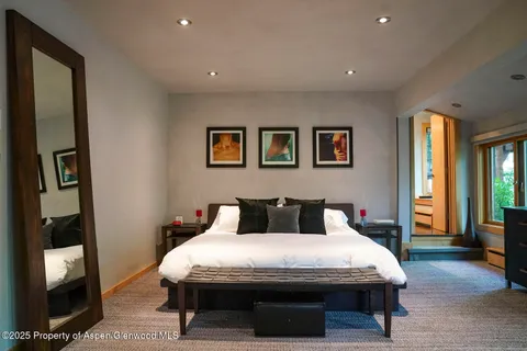 a bathroom with a granite countertop sink mirror bathtub and toilet