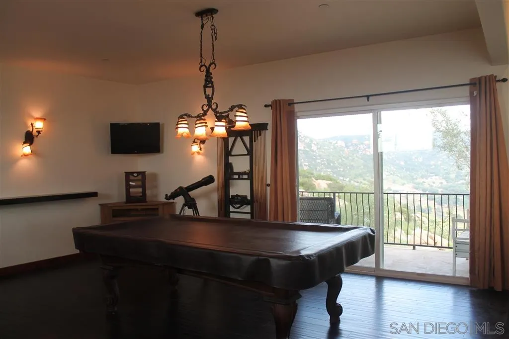 17315 Lyons Creek Road Jamul, CA 91935 - Photo 11 of 25 a view of a dining room with furniture window and wooden floor