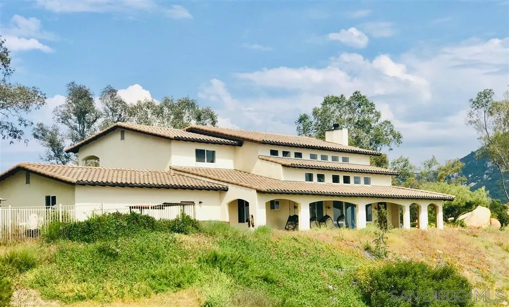 17315 Lyons Creek Road Jamul, CA 91935 - Photo 21 of 25 a front view of a house with a garden