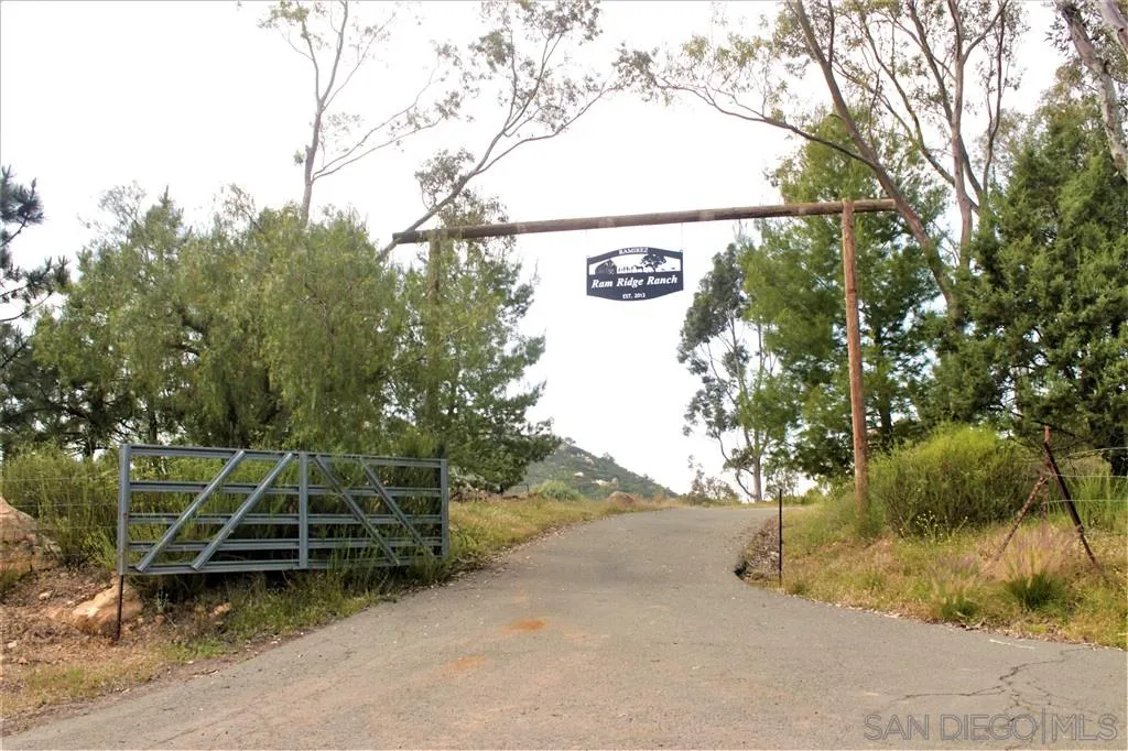 17315 Lyons Creek Road Jamul, CA 91935 - Photo 22 of 25 a view of a wooden house with large trees