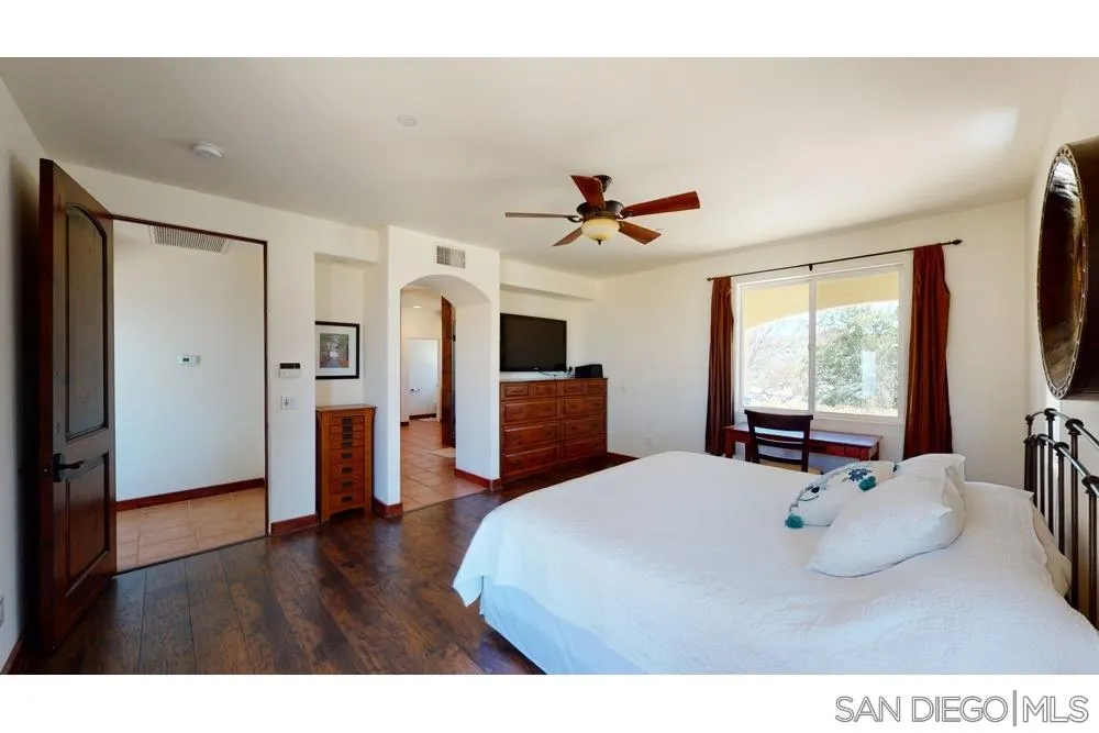 17315 Lyons Creek Road Jamul, CA 91935 - Photo 8 of 25 a bedroom with a bed and wooden floor