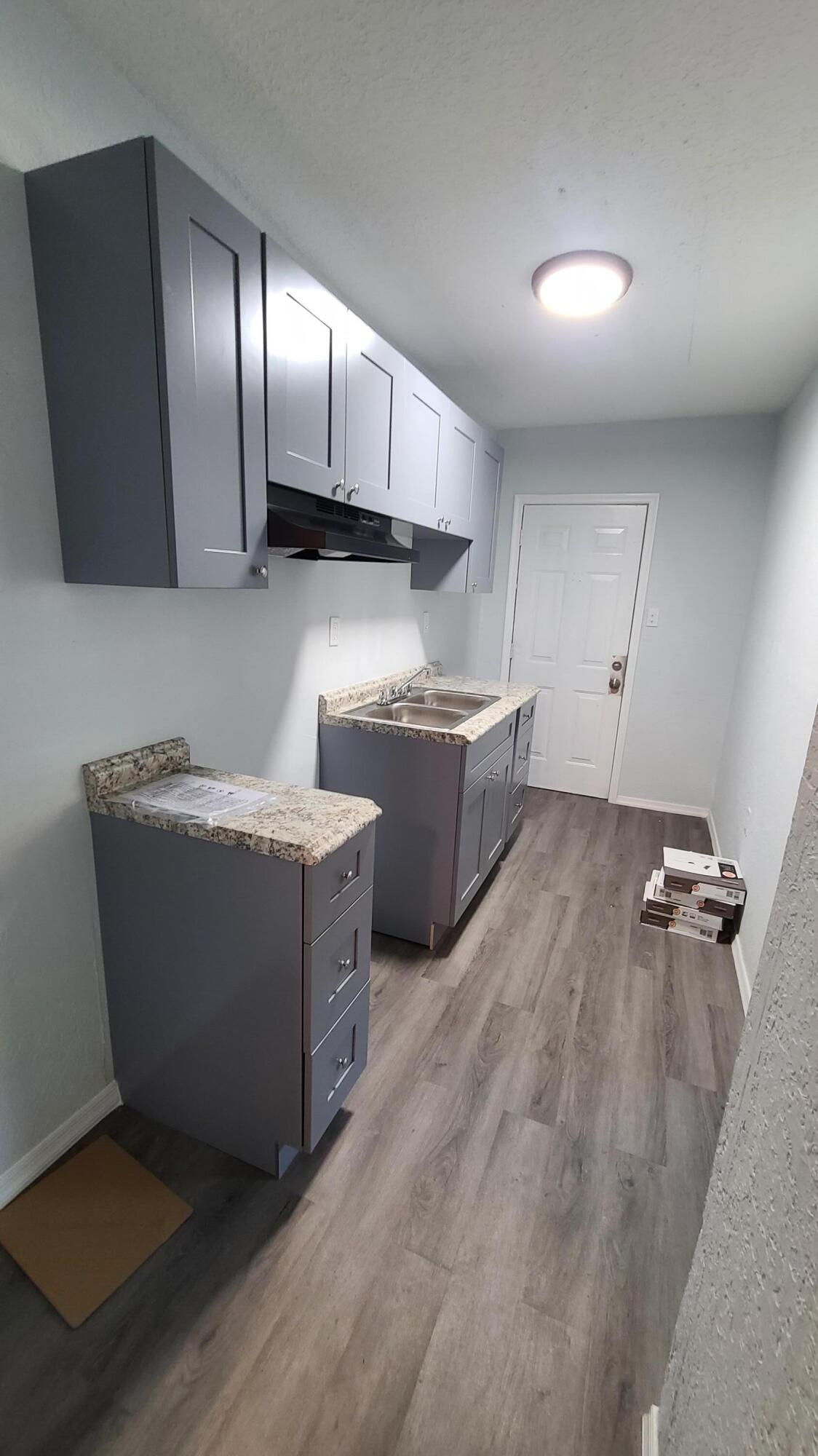 921 14th Street West Palm Beach, FL 33401 - Photo 11 of 36 a room with wooden cabinets