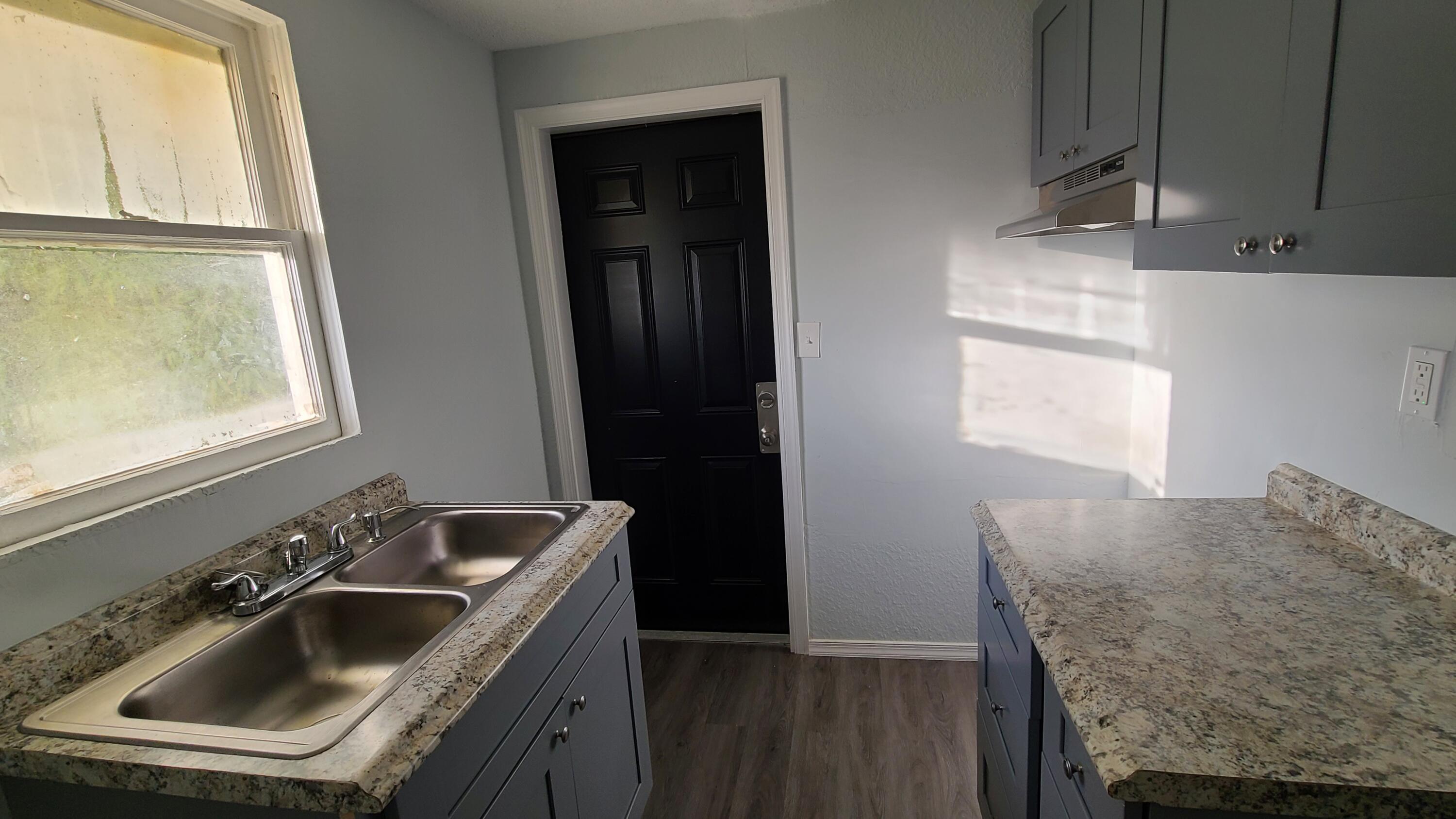 921 14th Street West Palm Beach, FL 33401 - Photo 12 of 36 a kitchen with a sink stove and refrigerator