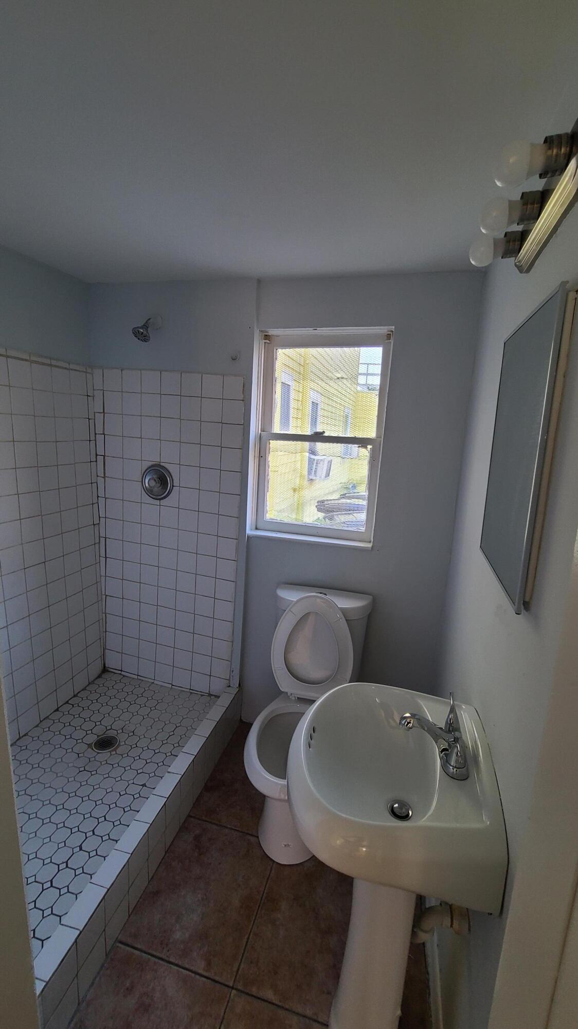 921 14th Street West Palm Beach, FL 33401 - Photo 15 of 36 a bathroom with a sink toilet and shower