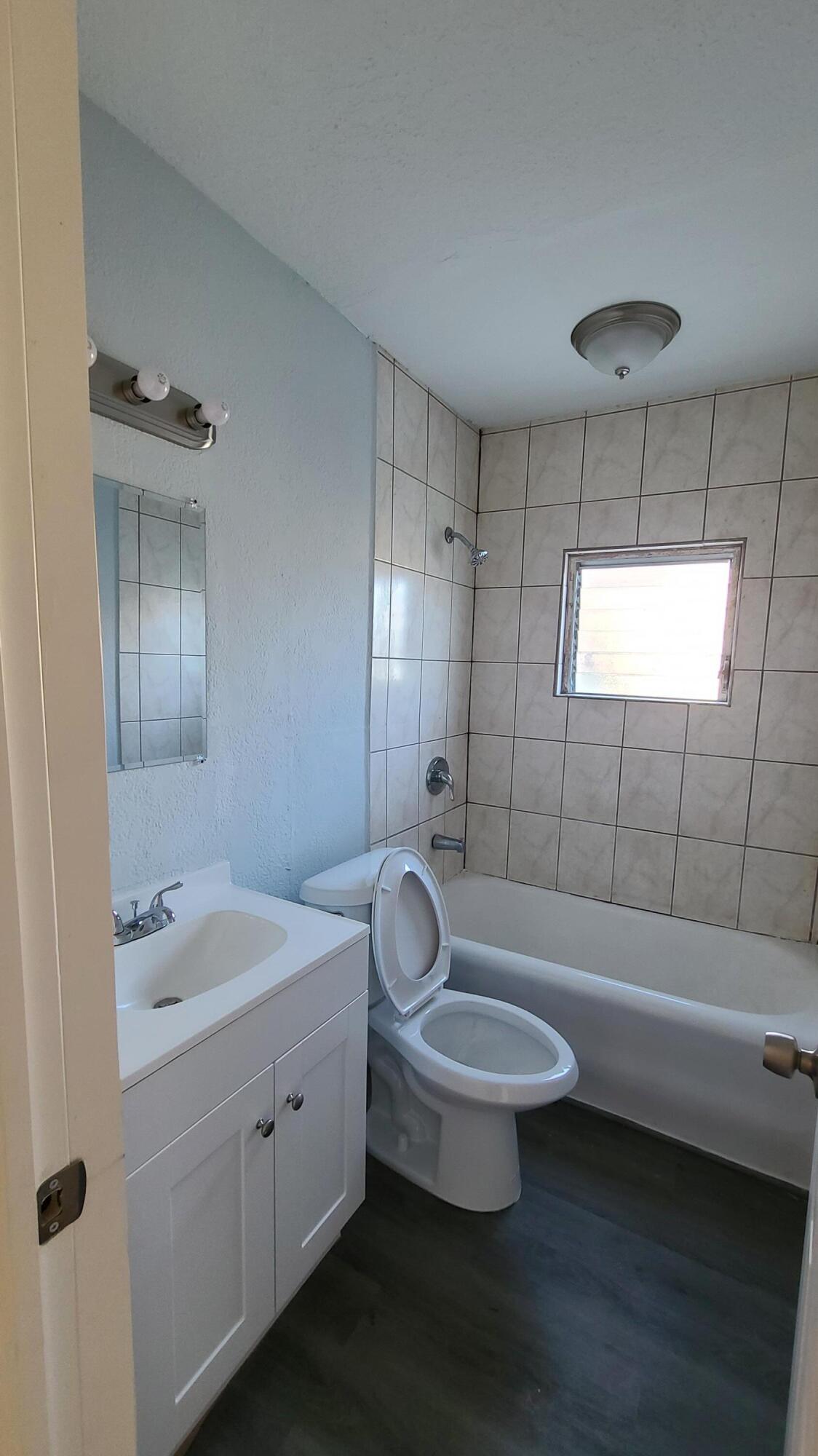 921 14th Street West Palm Beach, FL 33401 - Photo 18 of 36 a bathroom with a double vanity sink toilet and shower