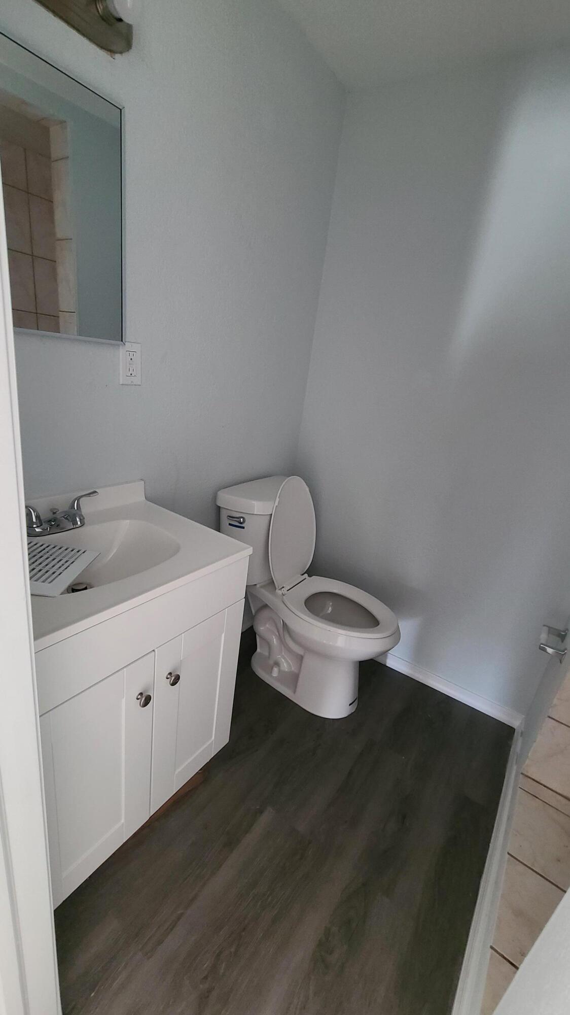 921 14th Street West Palm Beach, FL 33401 - Photo 19 of 36 a bathroom with a toilet sink and mirror