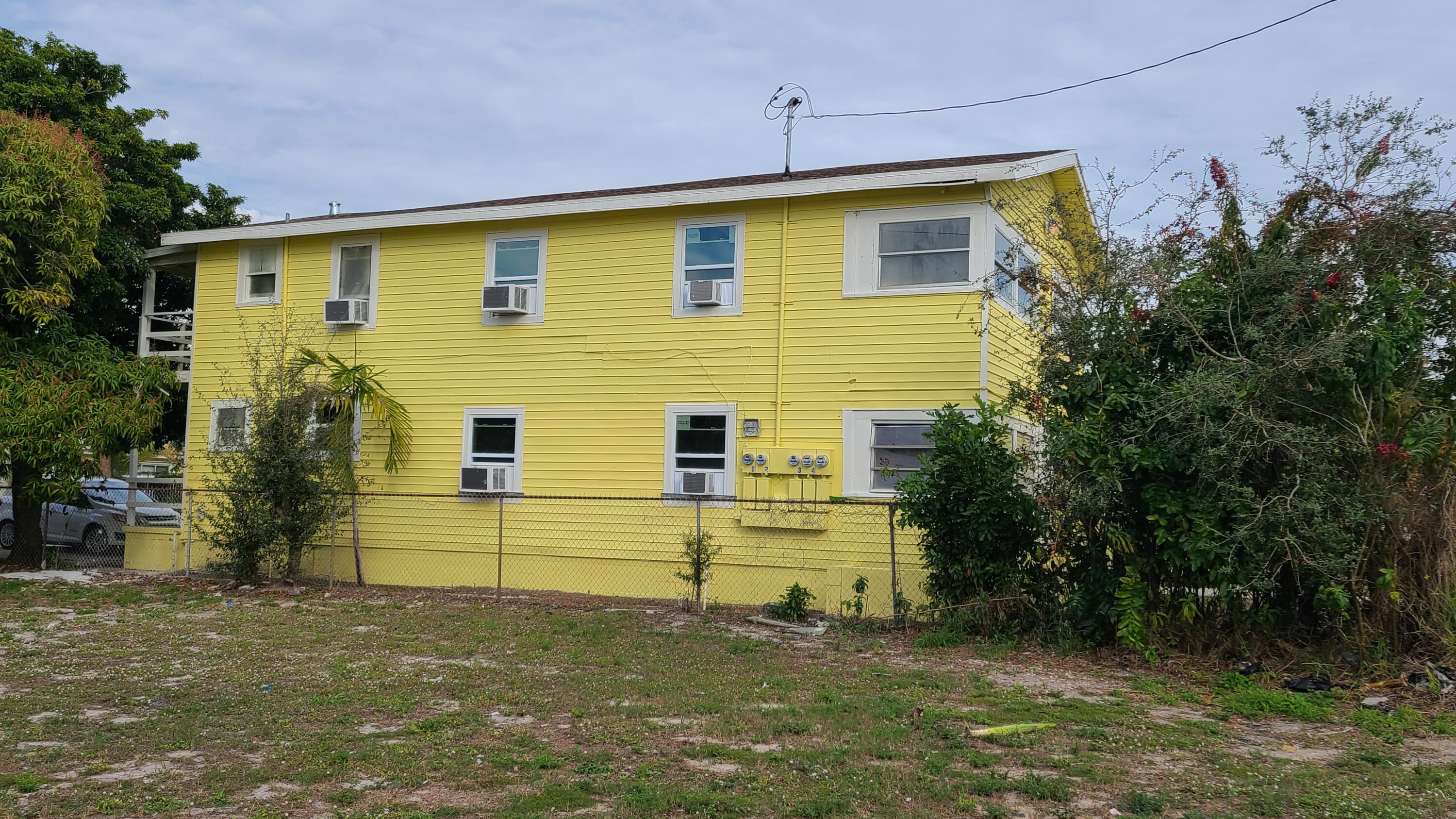 921 14th Street West Palm Beach, FL 33401 - Photo 2 of 36 a front view of a house with a yard