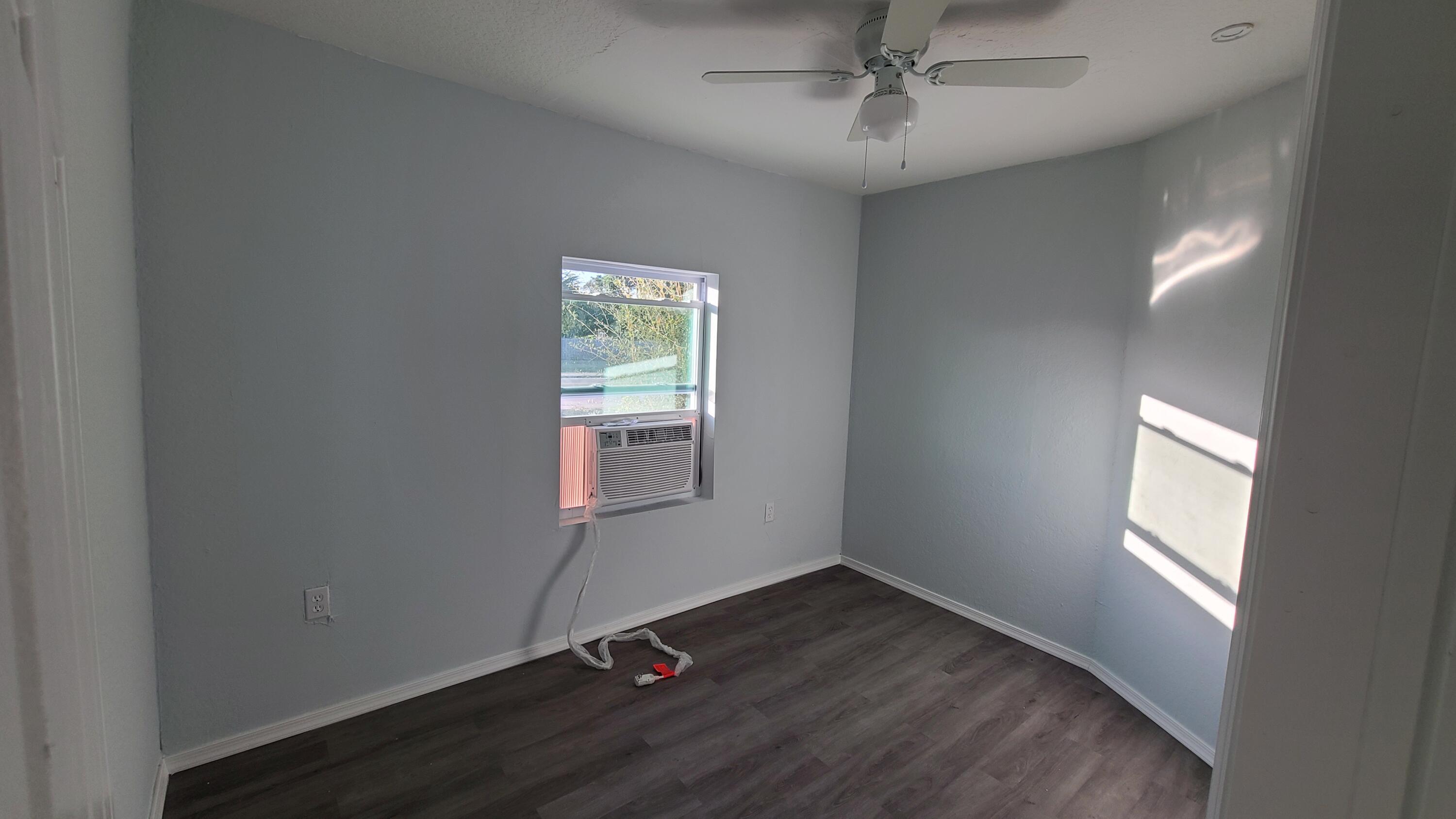 921 14th Street West Palm Beach, FL 33401 - Photo 22 of 36 an empty room with wooden floor windows and fan