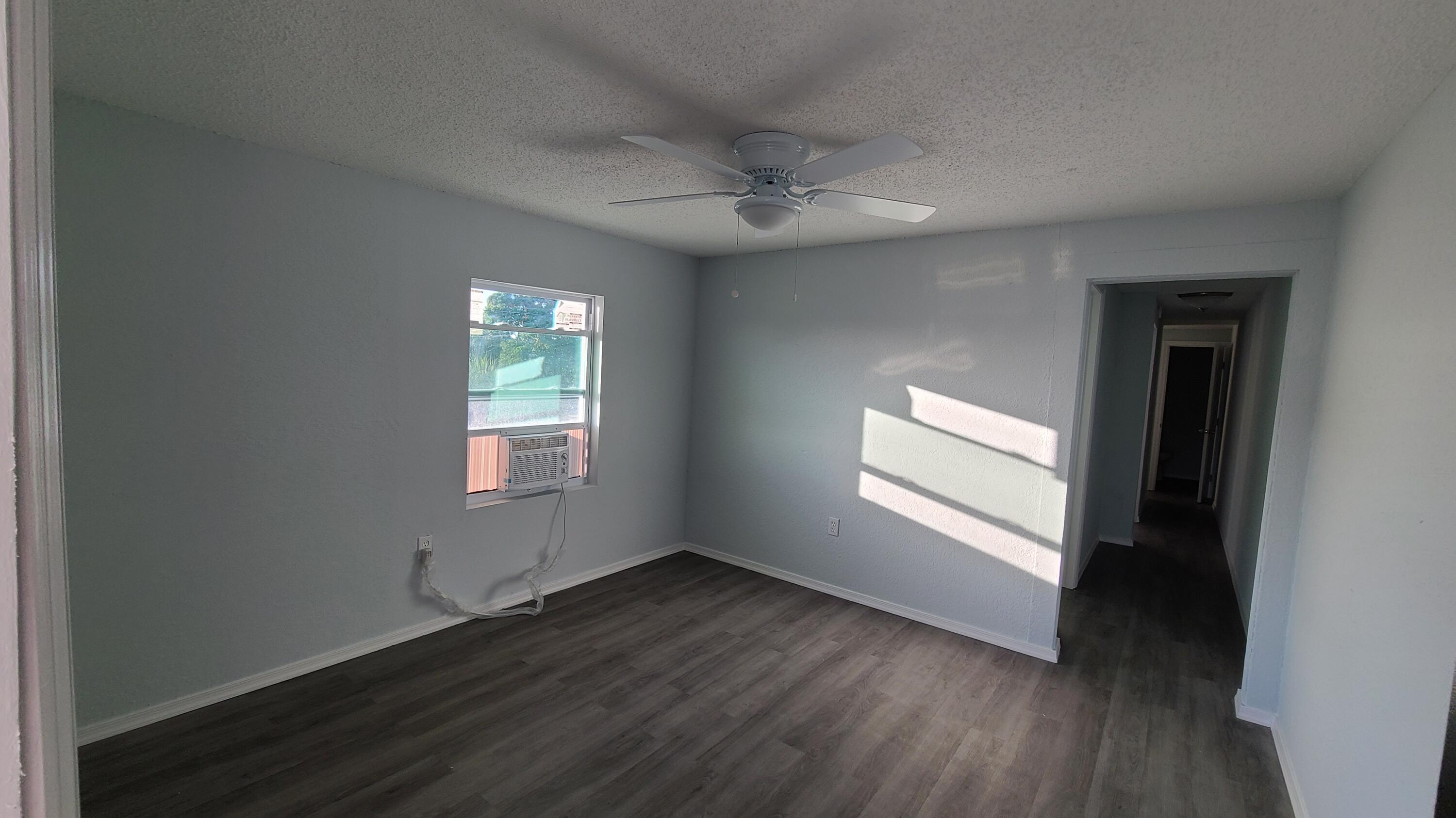 921 14th Street West Palm Beach, FL 33401 - Photo 28 of 36 an empty room with wooden floor and windows