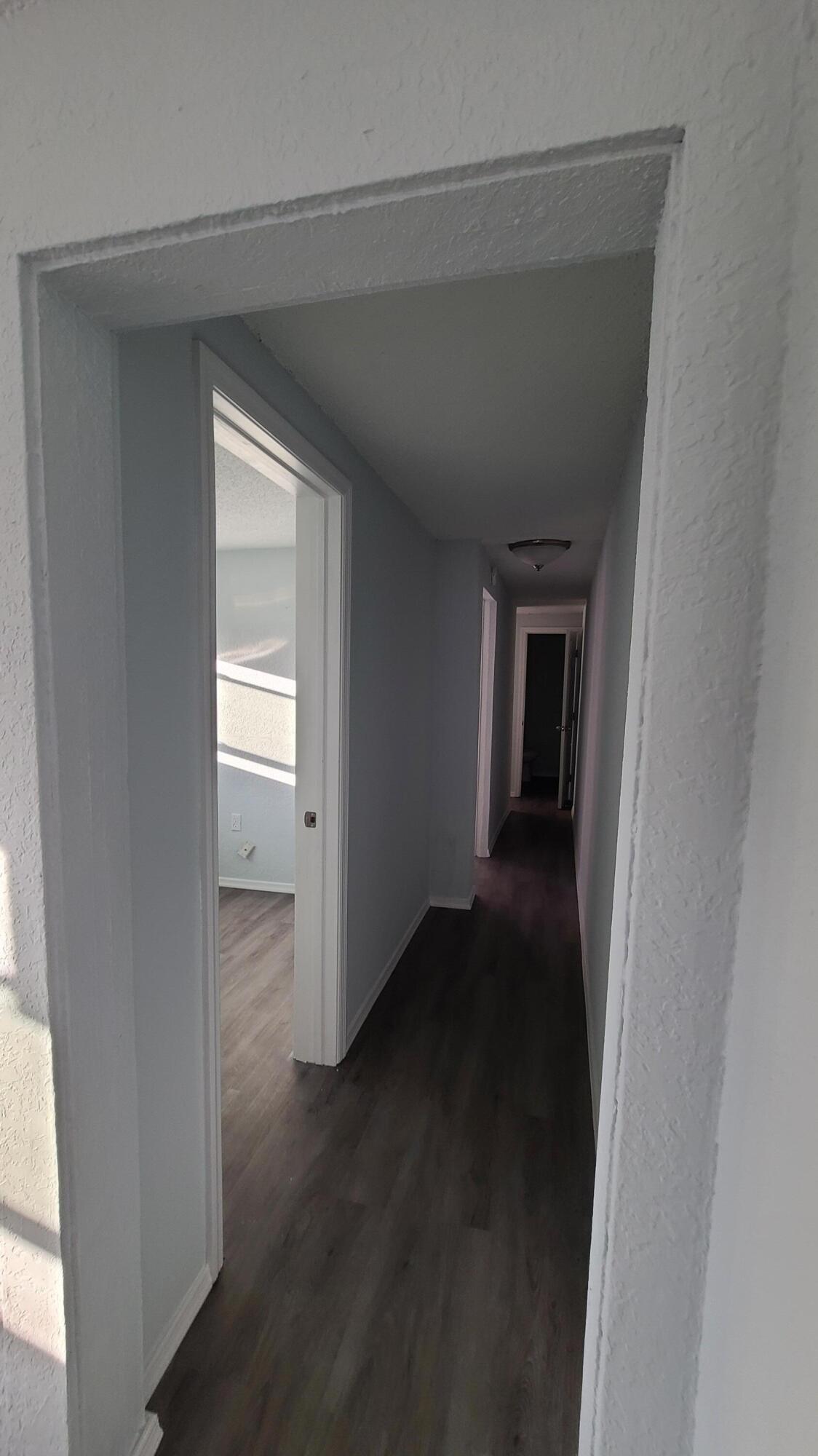 921 14th Street West Palm Beach, FL 33401 - Photo 29 of 36 a view of a hallway with wooden floor and closet area