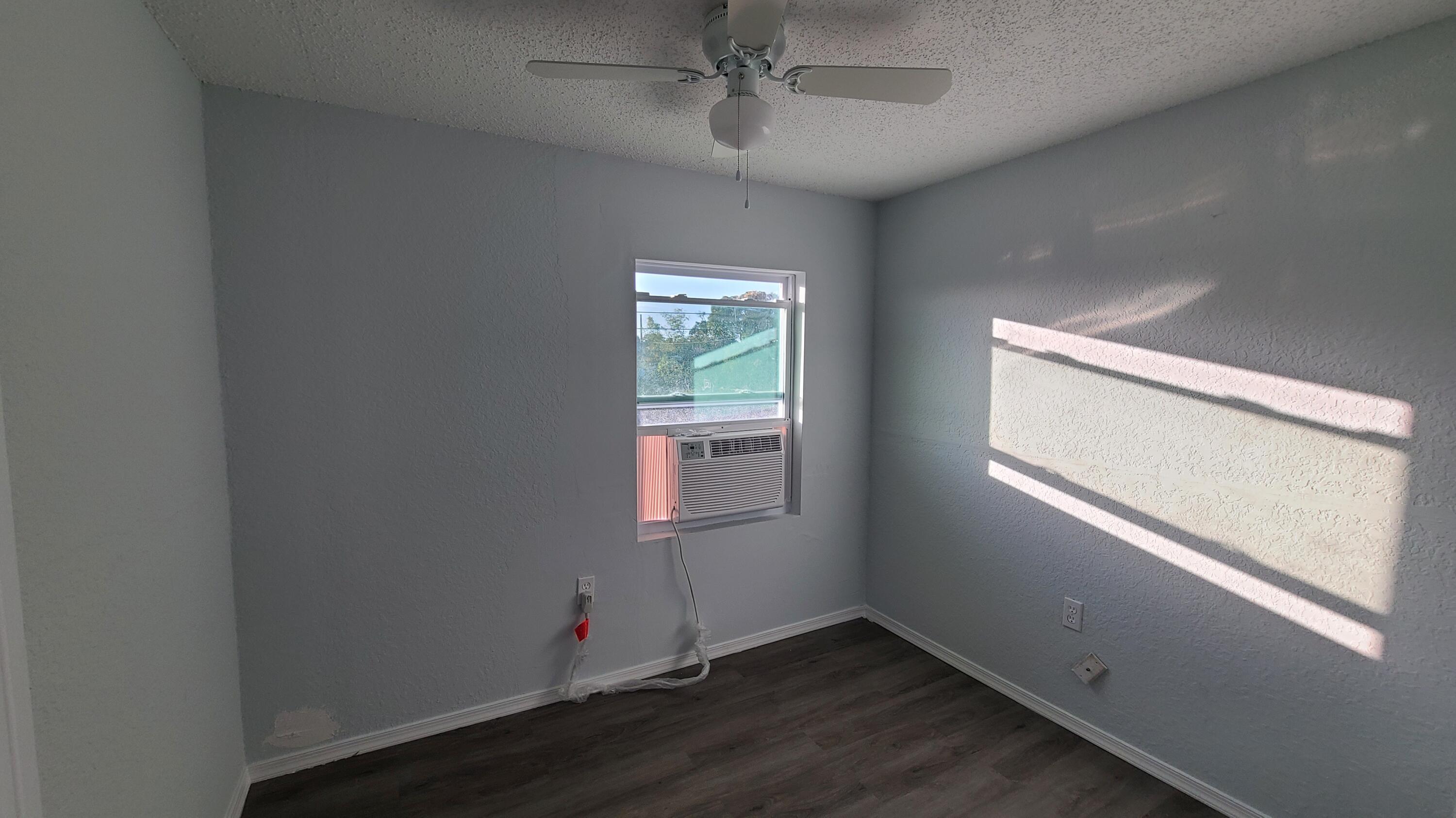 921 14th Street West Palm Beach, FL 33401 - Photo 30 of 36 an empty room with wooden floor and windows