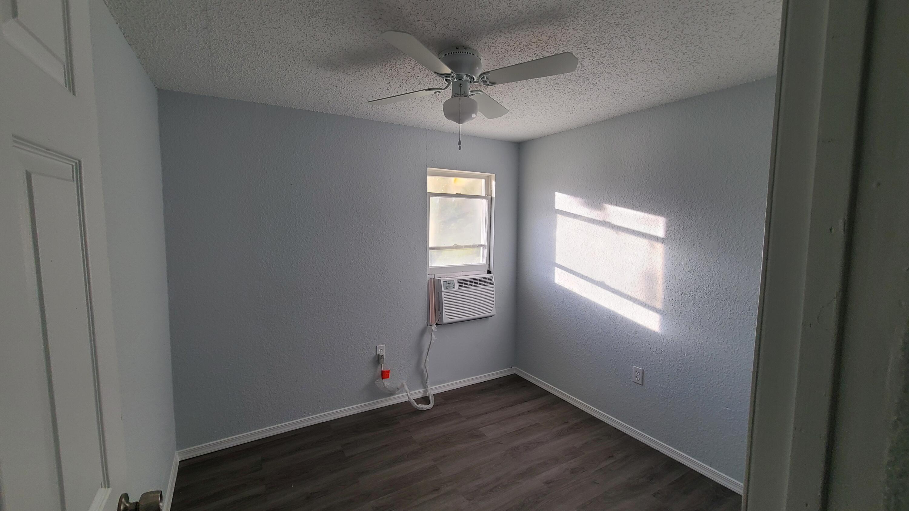 921 14th Street West Palm Beach, FL 33401 - Photo 31 of 36 an empty room with wooden floor and windows