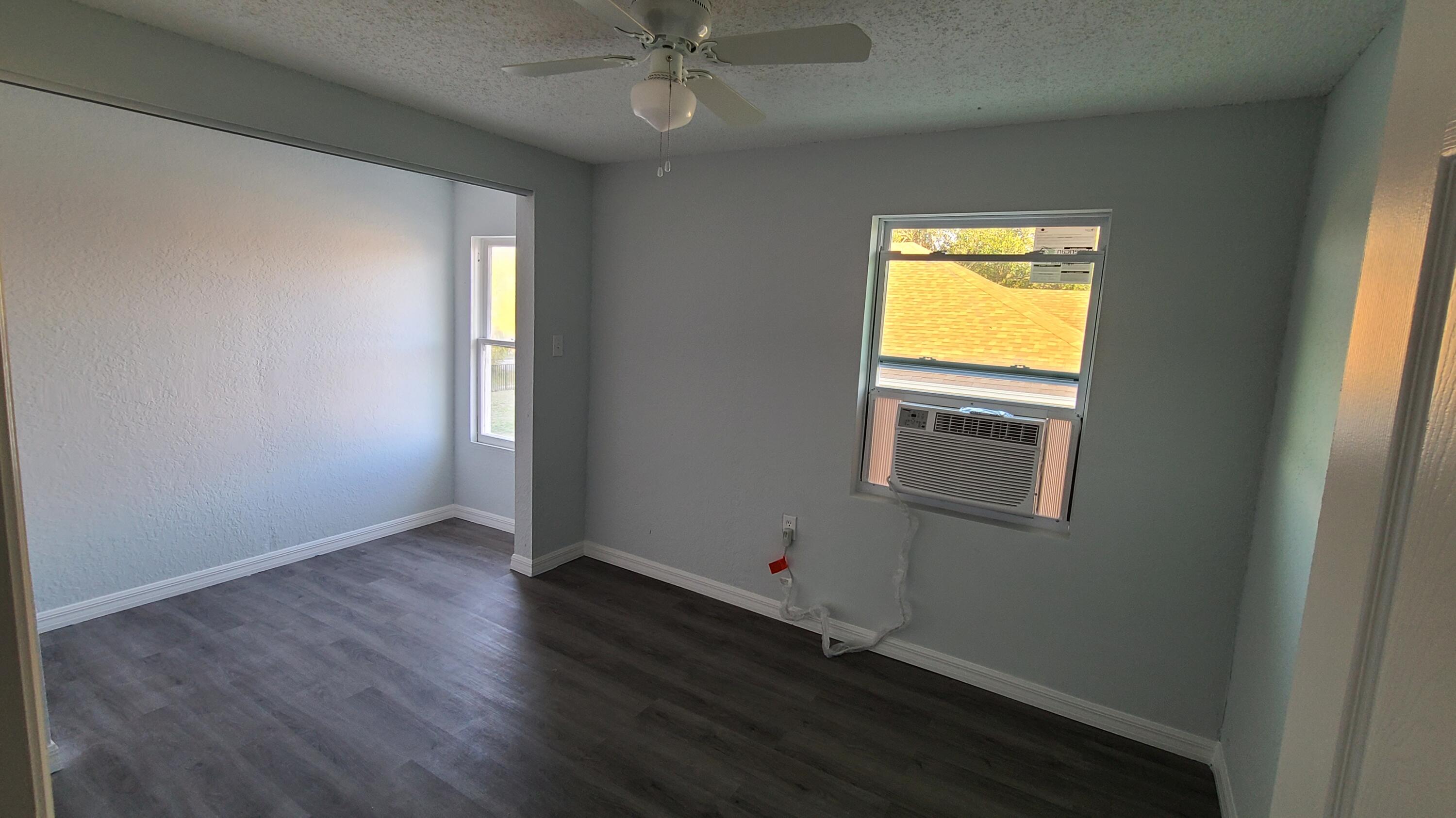 921 14th Street West Palm Beach, FL 33401 - Photo 34 of 36 an empty room with a window and wooden floor
