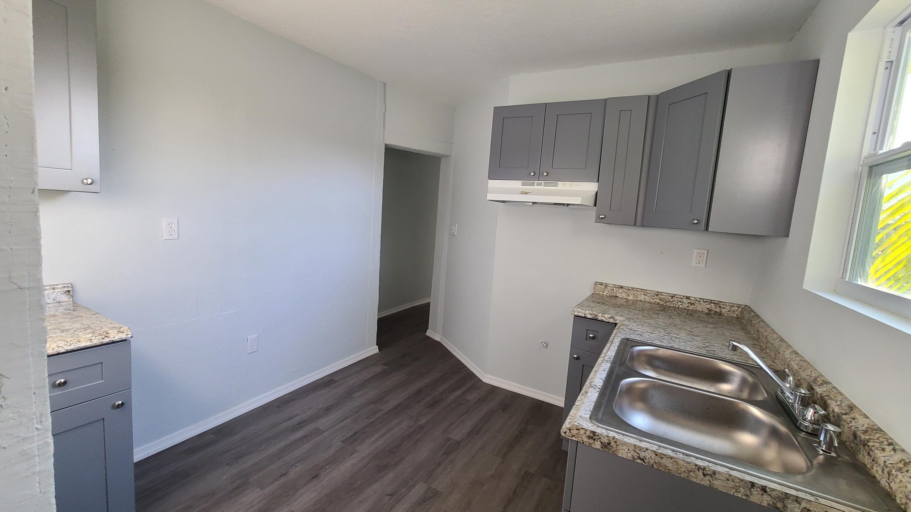 921 14th Street West Palm Beach, FL 33401 - Photo 10 of 36 a view of an empty room with a window and wooden floor