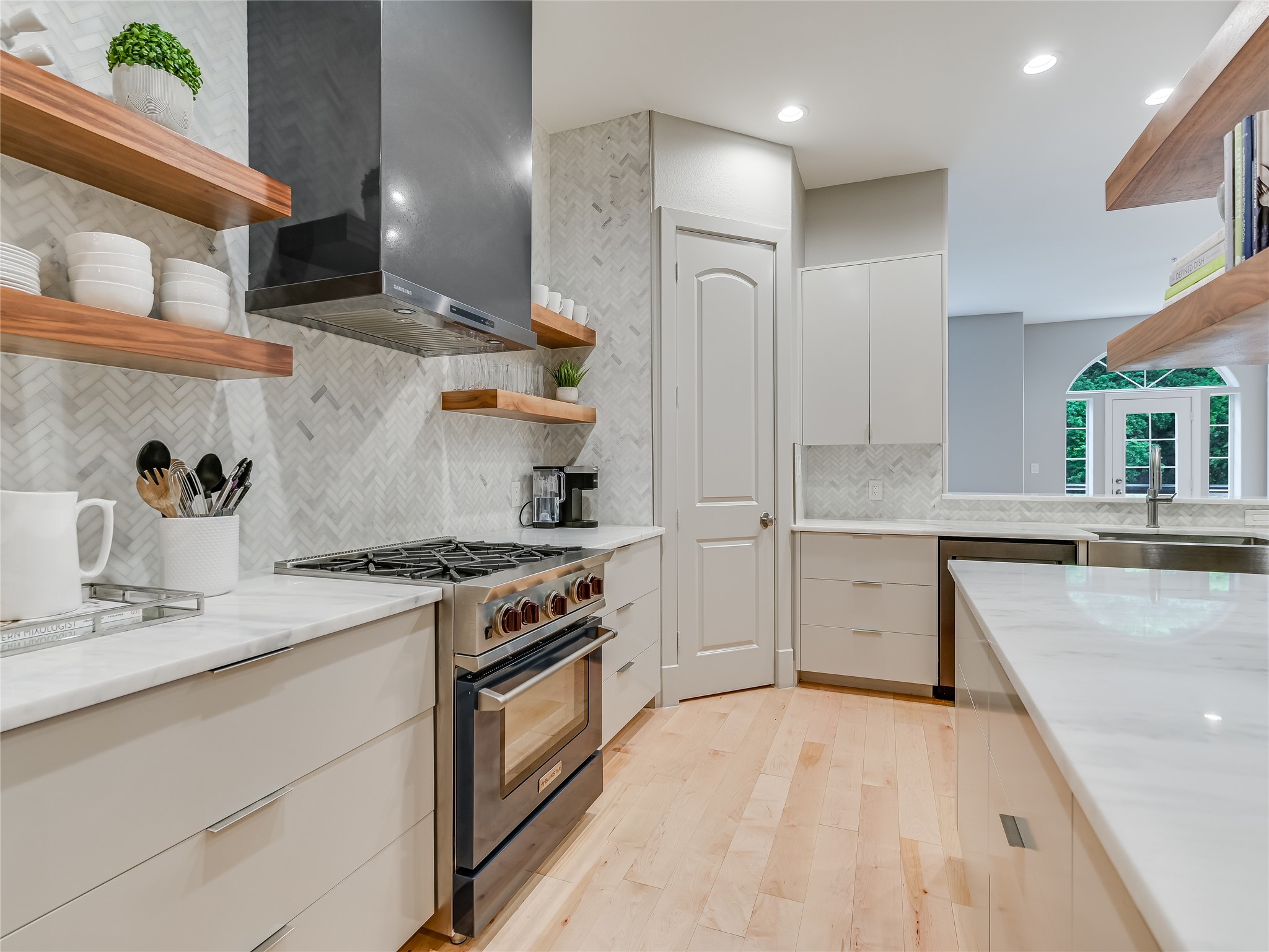 a kitchen with granite countertop a sink stove and refrigerator