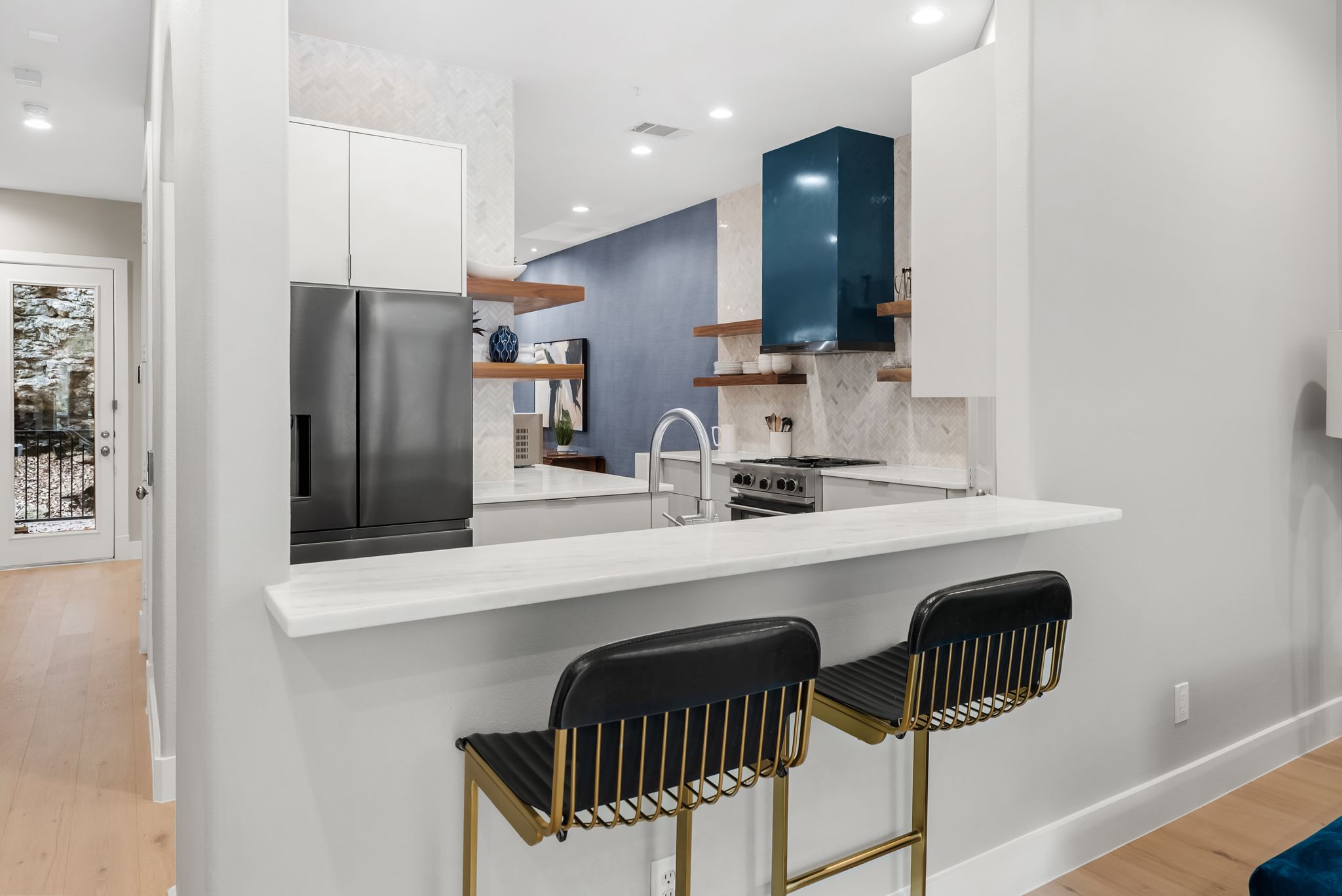 1529 Barton Springs Road, Unit 13 Austin, TX 78704 - Photo 9 of 35 a kitchen with a sink a refrigerator and chairs