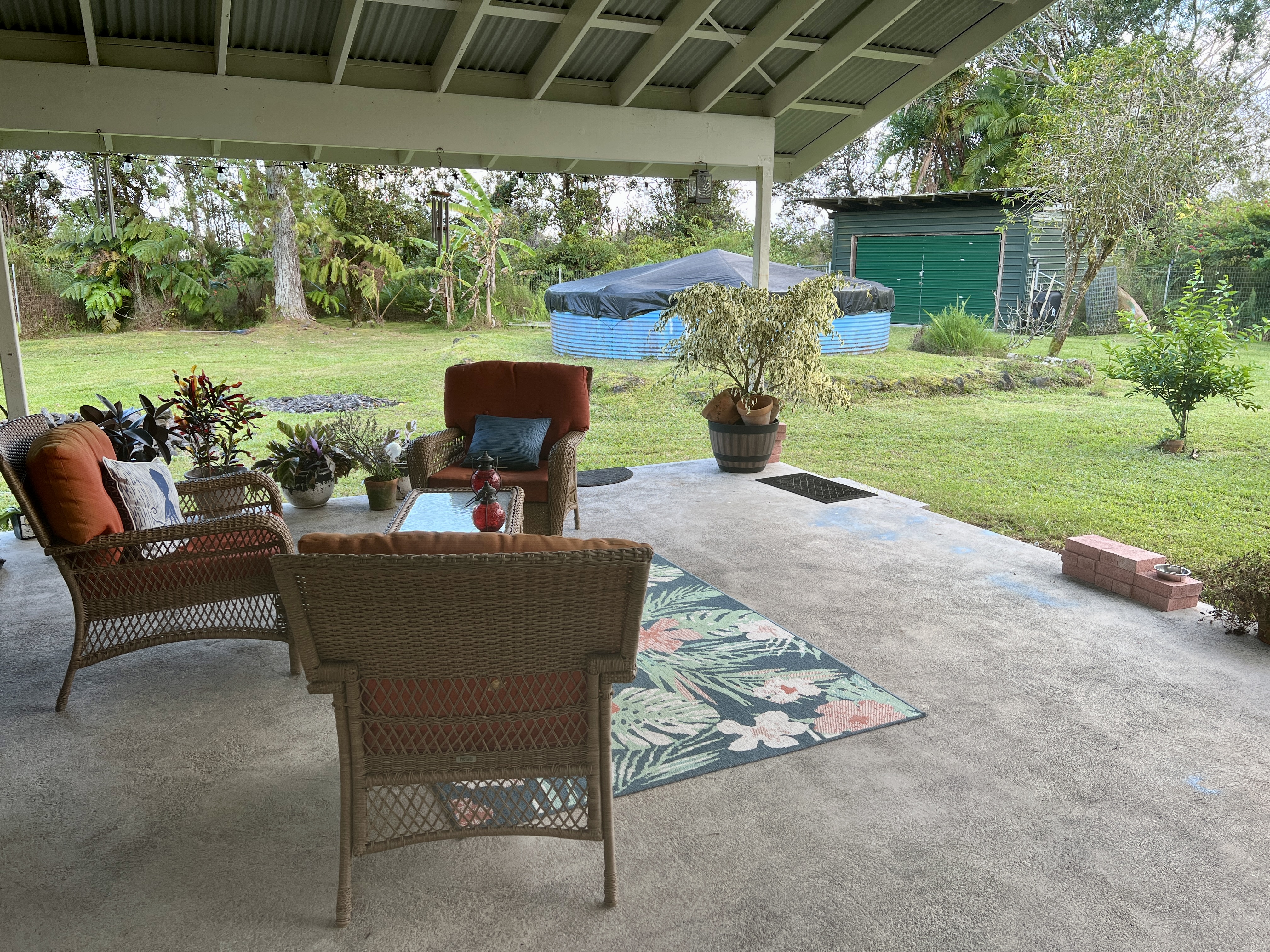 11-2485 Omeka Road Mountain View, HI 96771 - Photo 22 of 30 a view of a patio with a table chairs and a yard