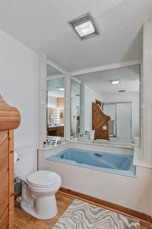 10307 Pirogue Road Oil City, LA 71061 - Photo 23 of 36 a bathroom with a toilet a sink and mirror