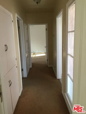 a view of a hallway to a bedroom