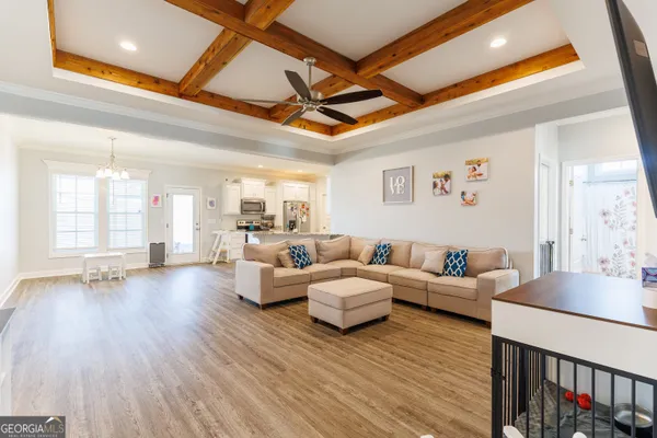 a living room with fireplace furniture and a wooden floor