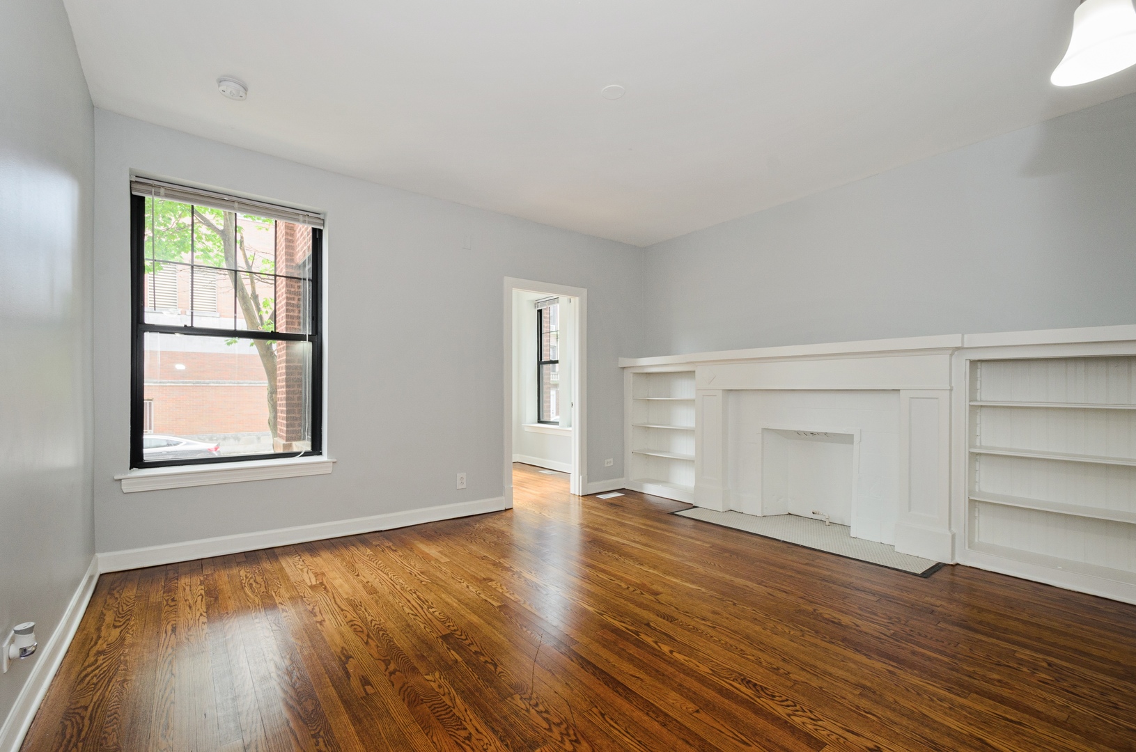 1642 West Jonquil Terrace, Unit 1 Chicago, IL 60626 - Photo 2 of 5 an empty room with wooden floor and windows