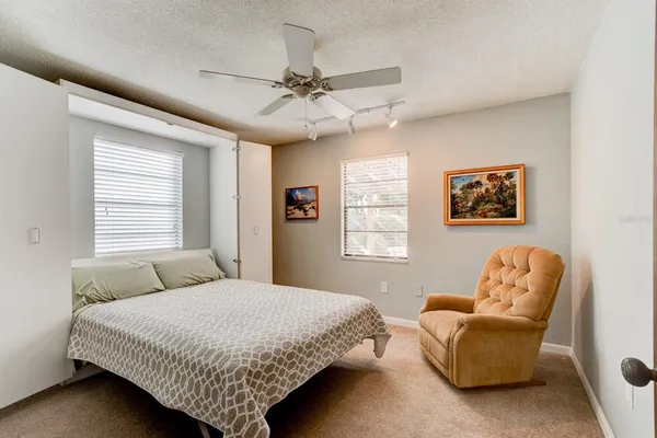 a bedroom with a bed and a couch