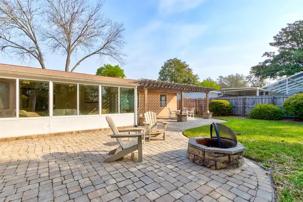 a view of a house with backyard sitting area and swimming pool