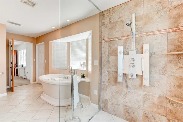 a living room with a patio and a chandelier fan